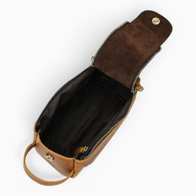 Le Voyage Prestige Sac de voyage compact en cuir véritable marron avec fermeture éclair et poignée latérale.